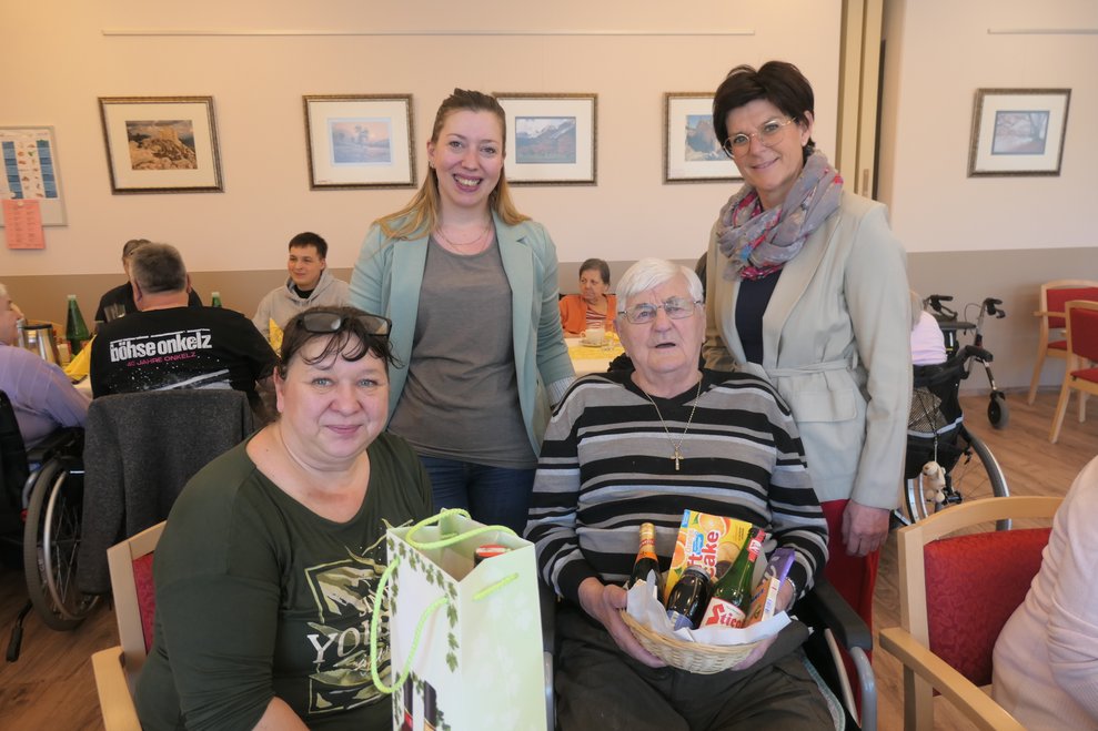 Vier Personen lächeln in die Kamera.