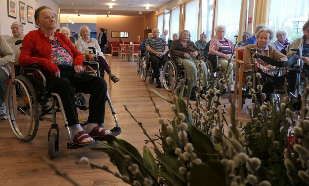 BewohnerInnen bei der Palmweihe im Festsaal